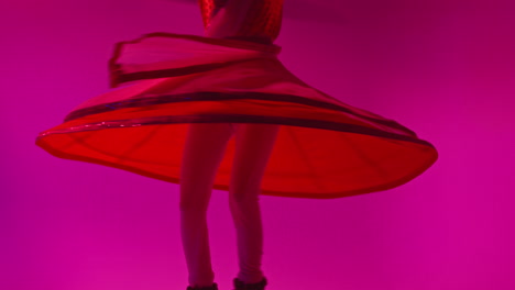 Spinning-Female-Kathak-Dancer-Performing-Dance-Wearing-Traditional-Indian-Dress-Against-Purple-Background-1