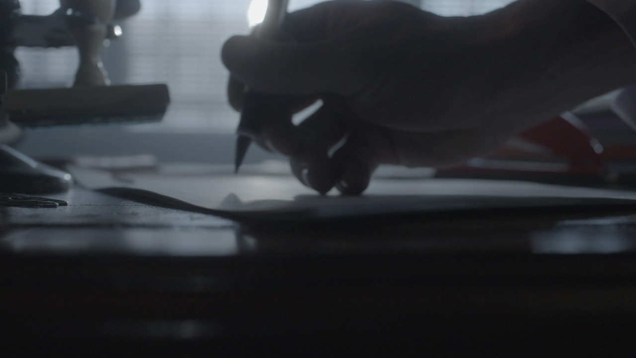 persona escribiendo en papel en un escritorio