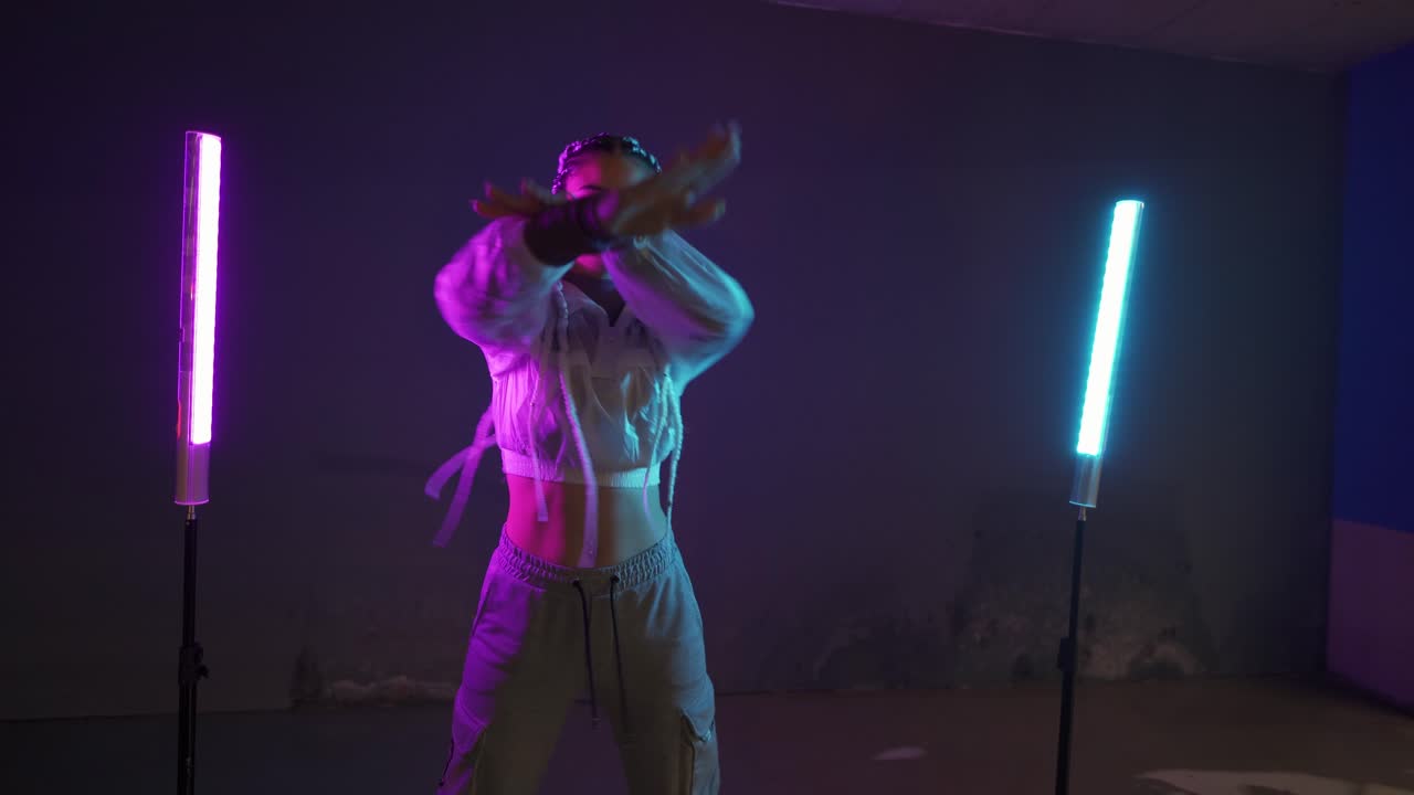 Woman Dancing in Neon Light Studio