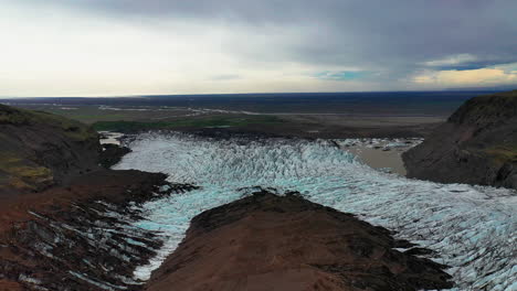 the stunning white svinafellsjokull glacier in south iceland with cloudy skies in background - aerial shot