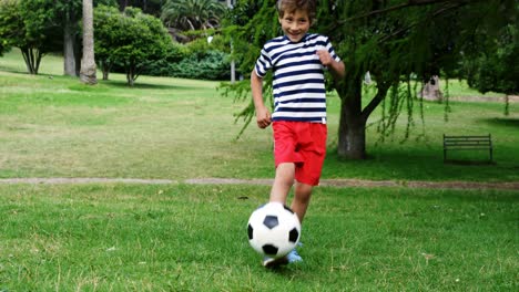 boy playing football in the park