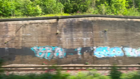 passenger's pov through the window of a moving train on a sunny day. timelapse