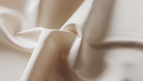 Close-up-of-white-shiny-silk-cloth-in-slow-motion