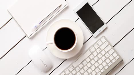 Devices-and-stationery-near-hot-drink