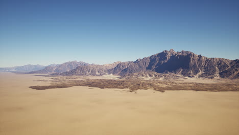 a vast desert landscape with mountains in the distance