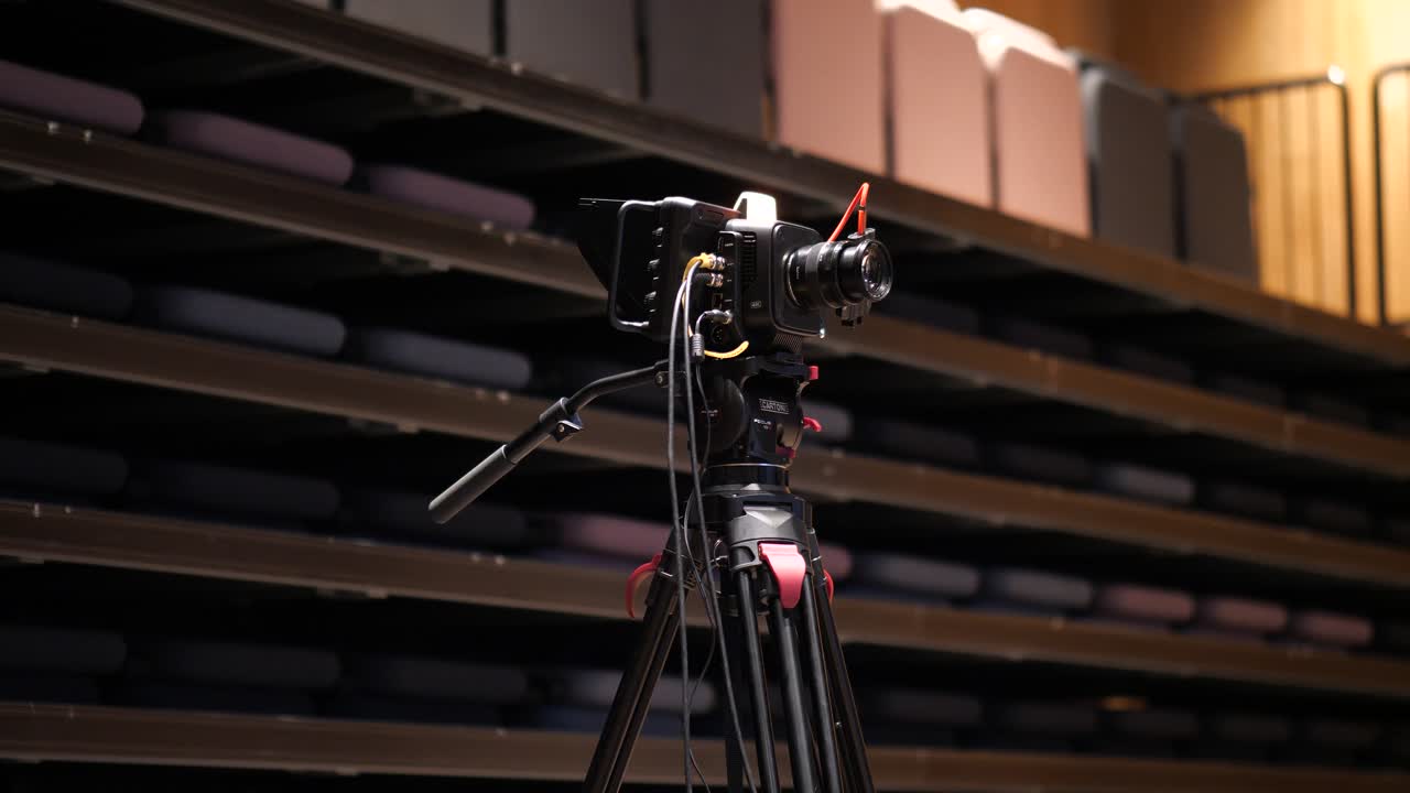 Professional cinema camera on a cinema tripod with gear connected ready to film