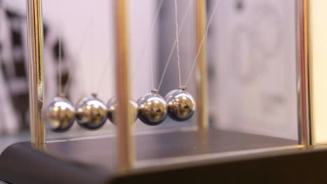 pendulum with swinging metal spheres in 4k slow motion 60fps