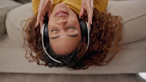 woman relaxing on the couch, listening to music