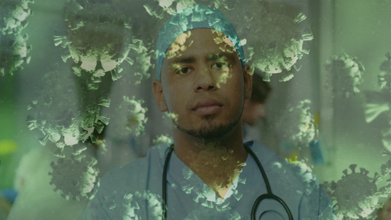 Animation of floating macro Covid-19 cells over biracial male doctor looking at camera