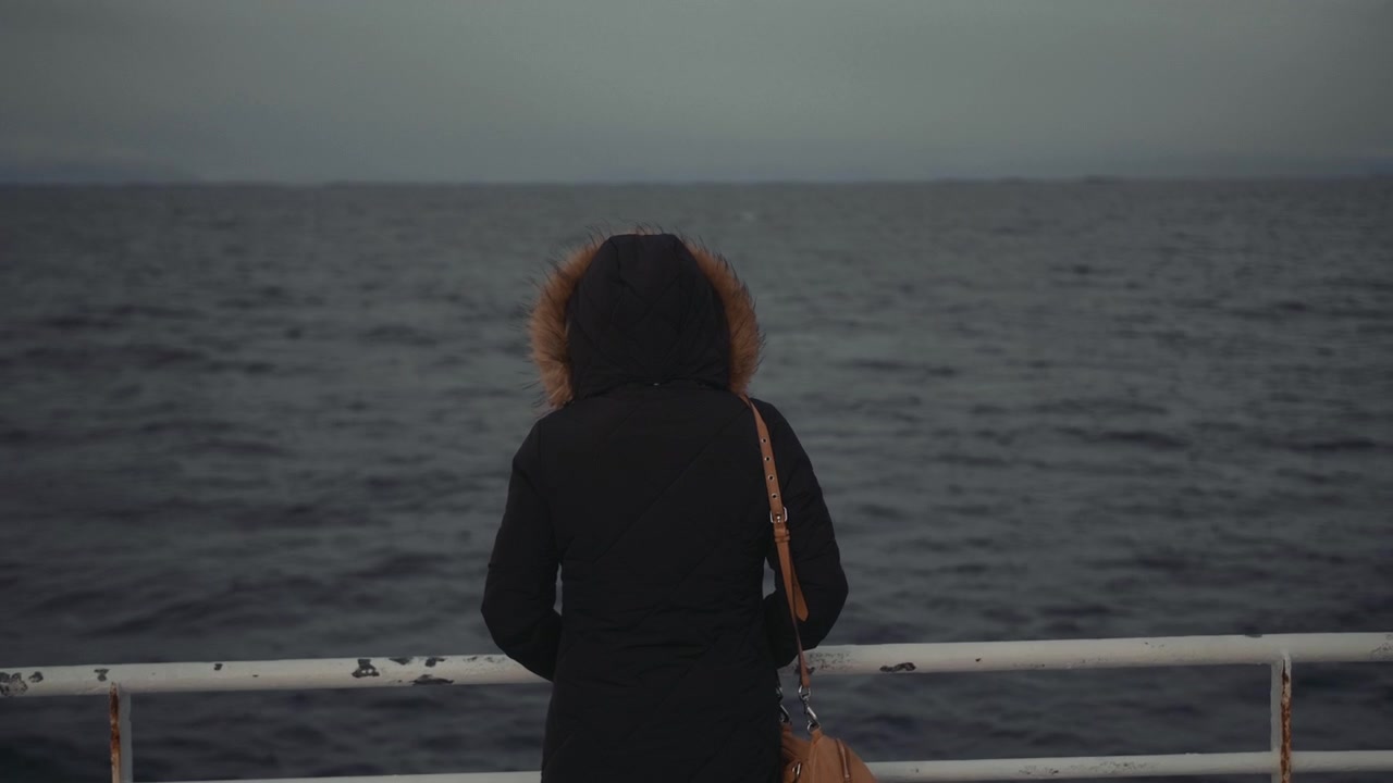 Woman in Hooded Jacket Looking at the Sea from a Ferry