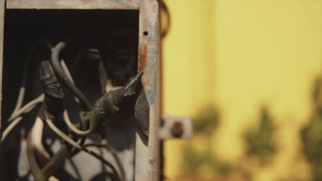 close up of an outdoor electrical box with taped wires and cables