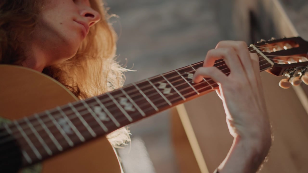 Bright guitar lesson. Caucasian instructor guides student. Sunlit studio showcases coaching specific techniques. Teacher provides gentle guitar instruction in sunlit loft studio setting