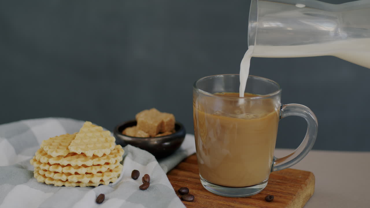 Pouring Milk into Coffee with Waffles and Brown Sugar