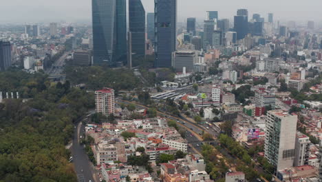 High-rise-modern-office-buildings-in-city-downtown-area-from-drone.-Aerial-cityscape-trucking-footage.-Mexico-city,-Mexico.