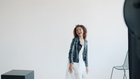 fashion photography of a woman in a white dress and leather jacket