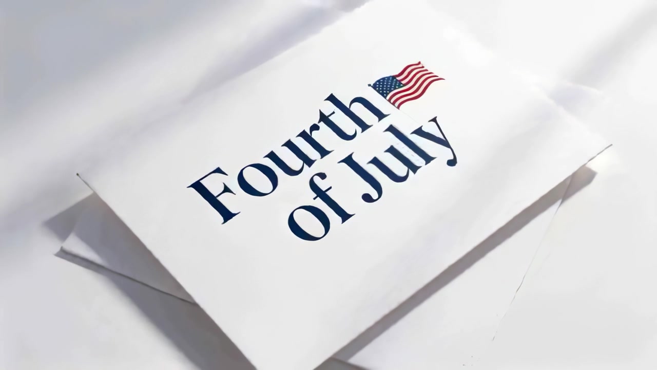 Rotating folded card from camera move on tabletop, revealing envelope and navy July Fourth flag
