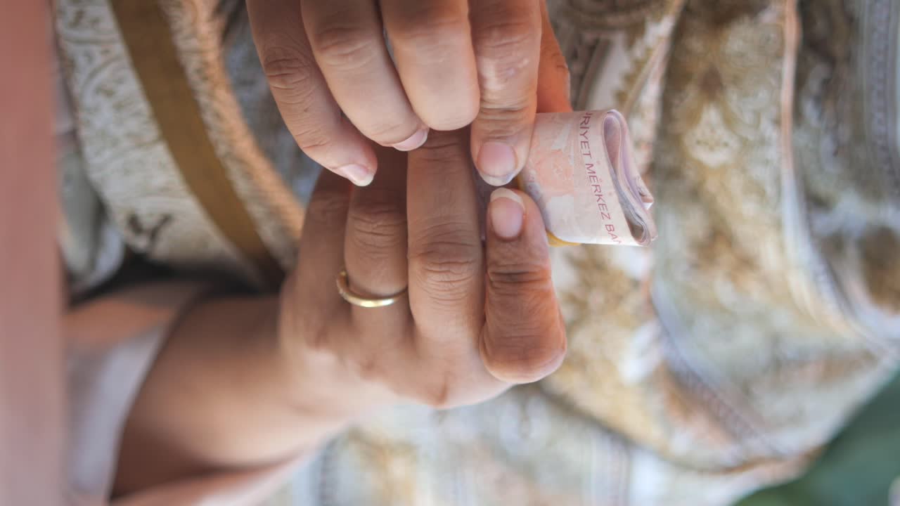 Hands holding rings and money