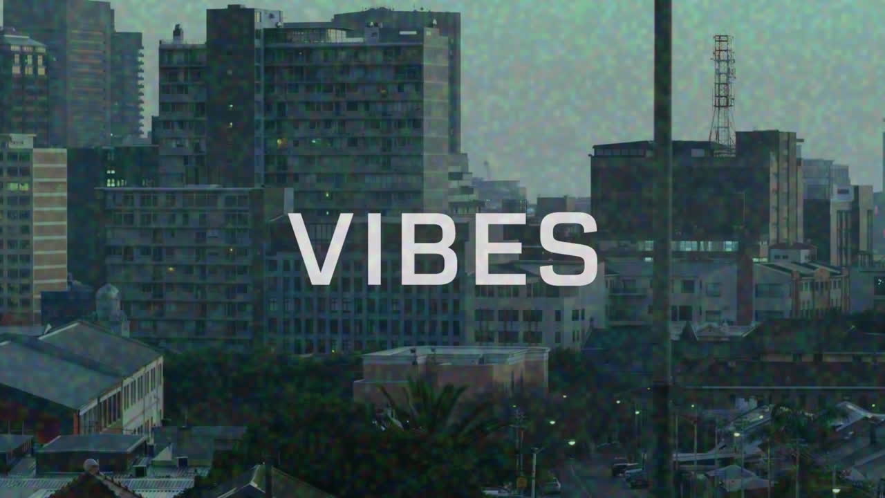 Animazione del testo "vibes" in bianco con effetto pixel su pellicola di paesaggio urbano