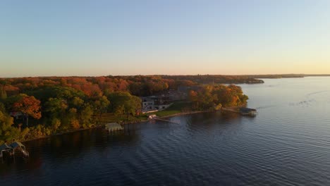 aerial view of a home surrounded by colorful trees during autumn color peak