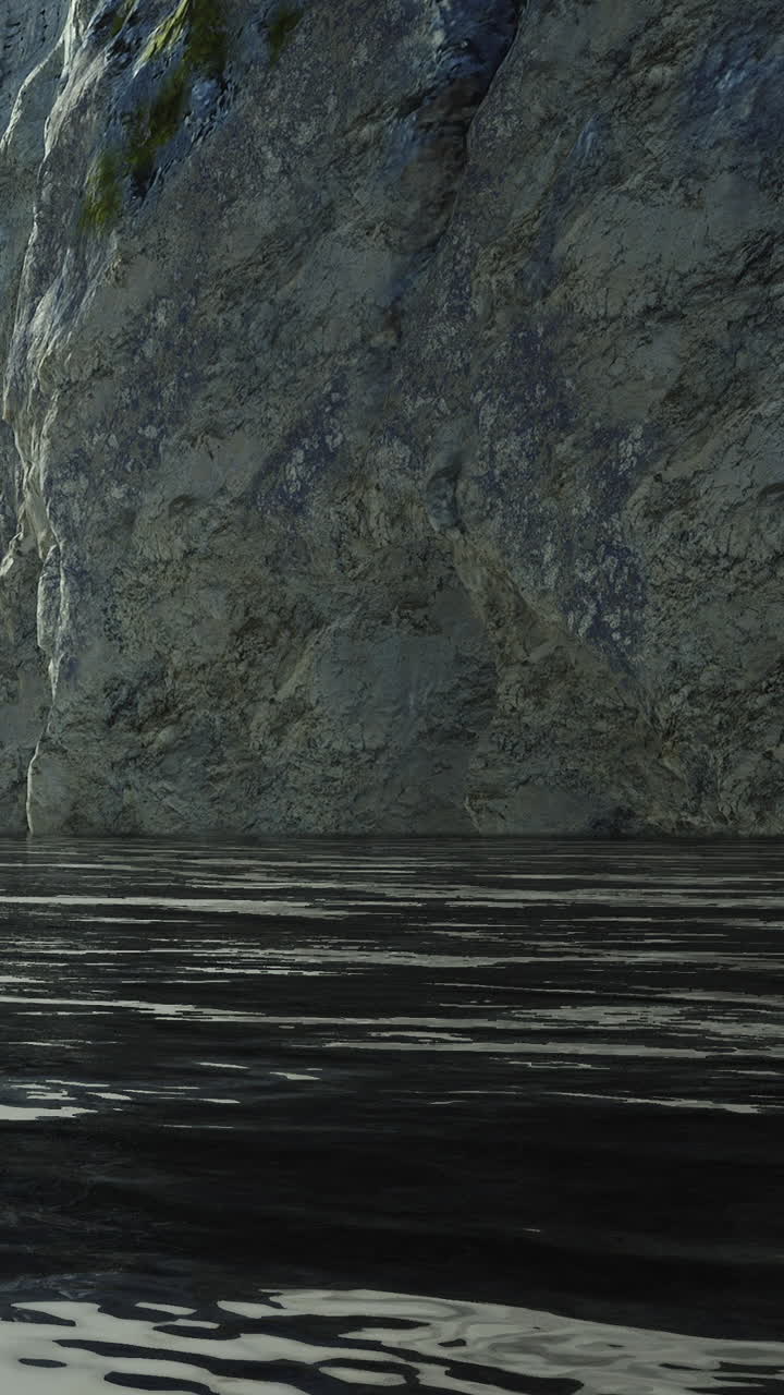 Rippling water reflects rocky cliffs at a remote lakeside