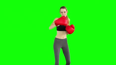 Fit-model-punching-with-red-boxing-gloves