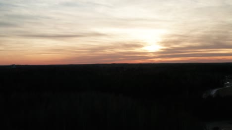 Pastel-cloudscape-with-sun,-Horizontal-zoom-aerial-shot