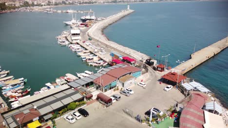 view of alanya and harbour at a sunny day. shore of mediterranean sea and historical alanya shipyard in turkey.