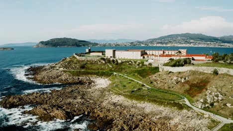 aerial view of hotel parador inside fortress monterreal on top of coastal hill in baiona, galicia spain