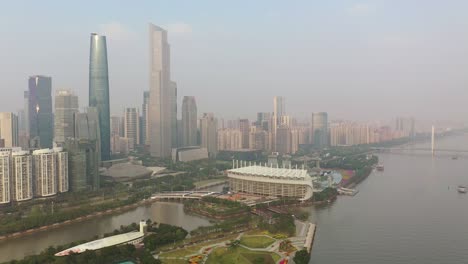 sunny evening guangzhou city downtown traffic bridge famous stadium riverside aerial panorama 4k china