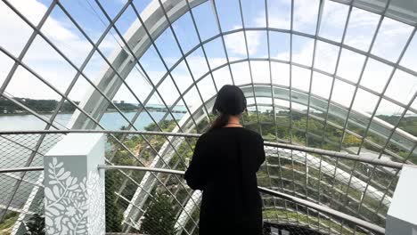 A-South-Asian-Woman-is-Strolling-Through-the-Cloud-Forest-Within-Gardens-By-The-Bay-in-Singapore---Tracking-Shot