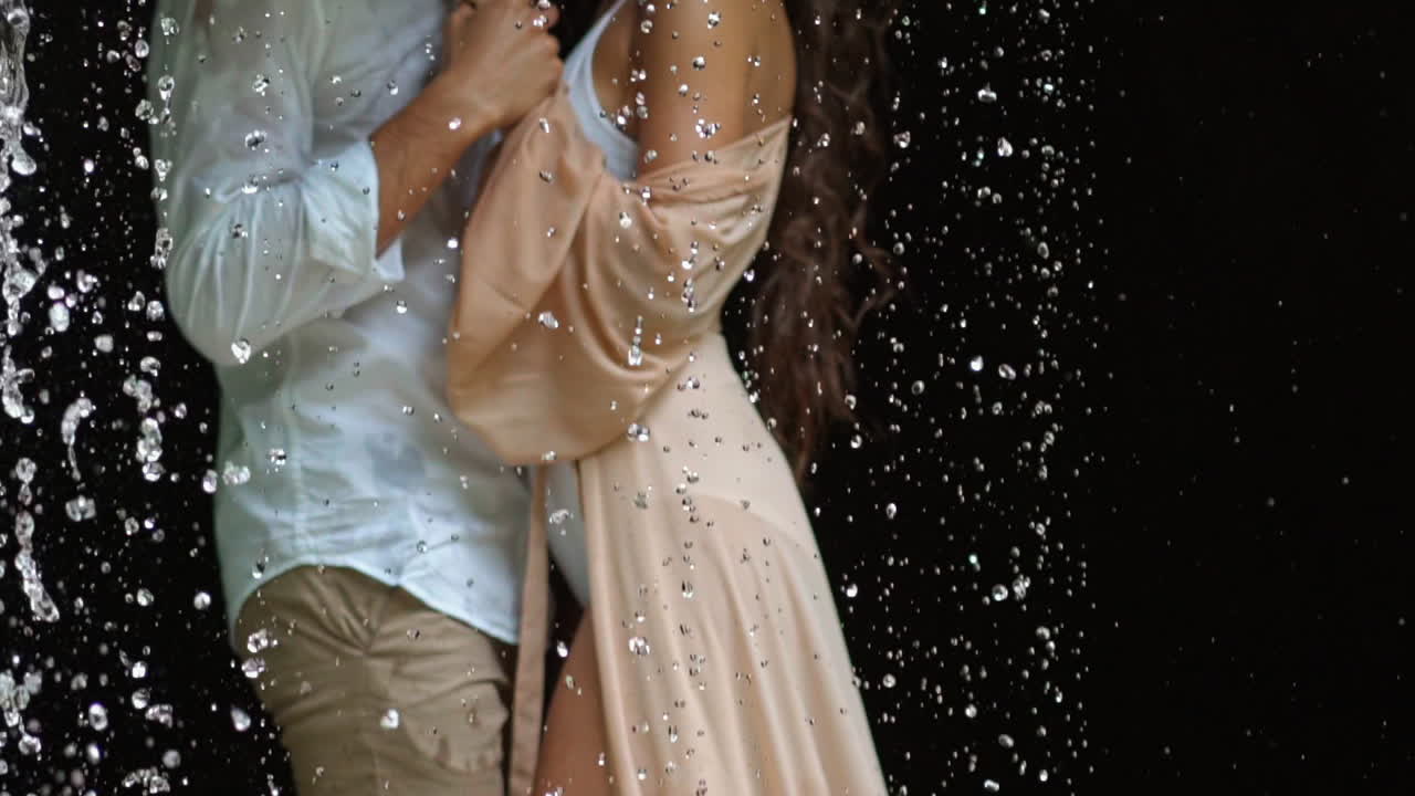 Couple of lovers under rain. Close up of couple in love hugging under rain
