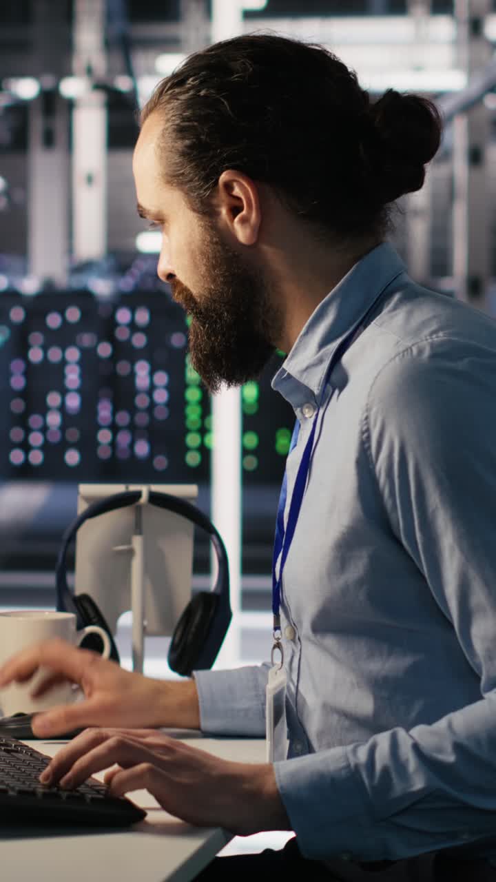 Vertical video Data center system administrator talking with coworker in office