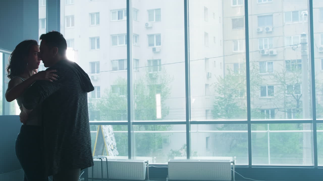 Couple Dancing Silhouetted Against a Large Window