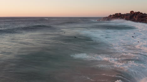 surfistas y grandes olas oceánicas en llandudno, ciudad del cabo, sudáfrica - toma aérea de drones