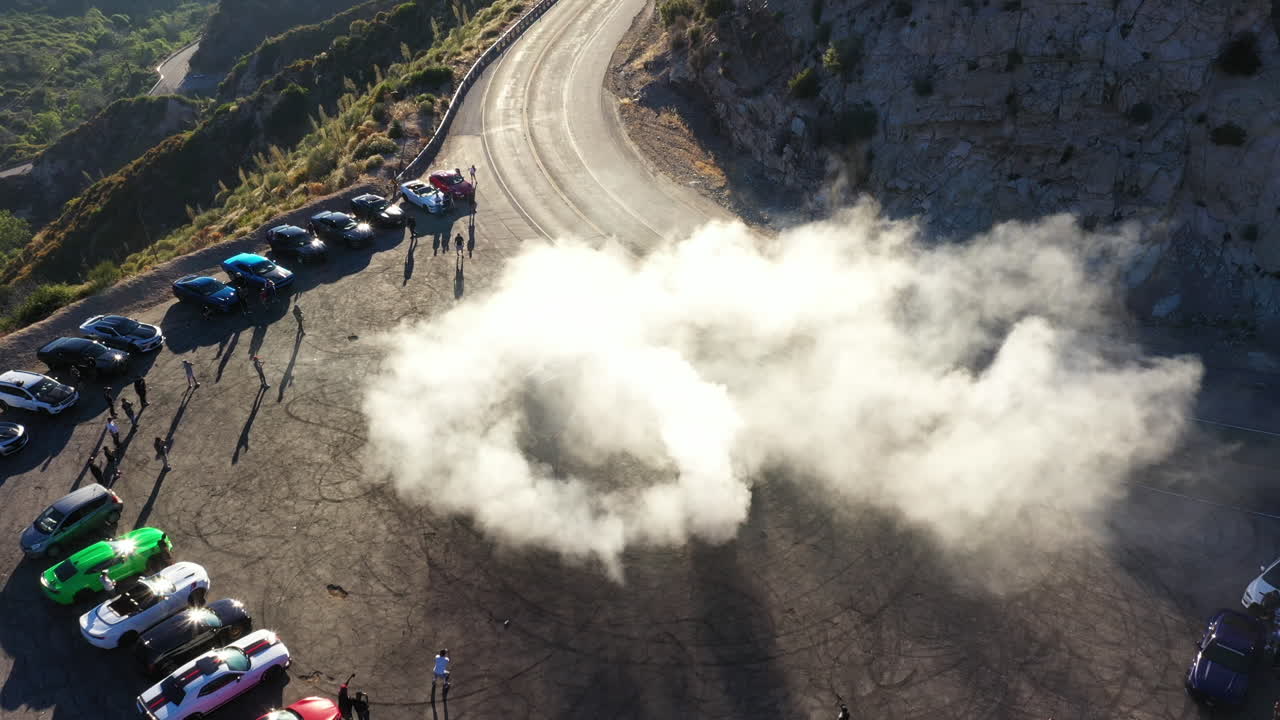Muscle and sports cars doing doughnuts and burnouts with a car club in the Angeles National Forest in Southern California