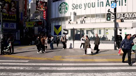 pedestrians crossing a busy urban intersection