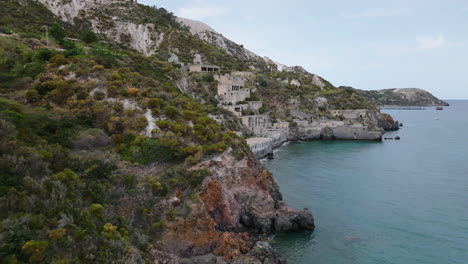 4k aerial lift and reveal lipari abandoned pomice mine accomodation, italy