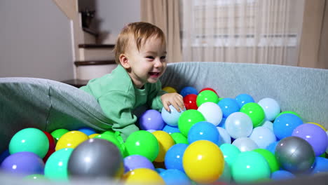 baby playing in a ball pit