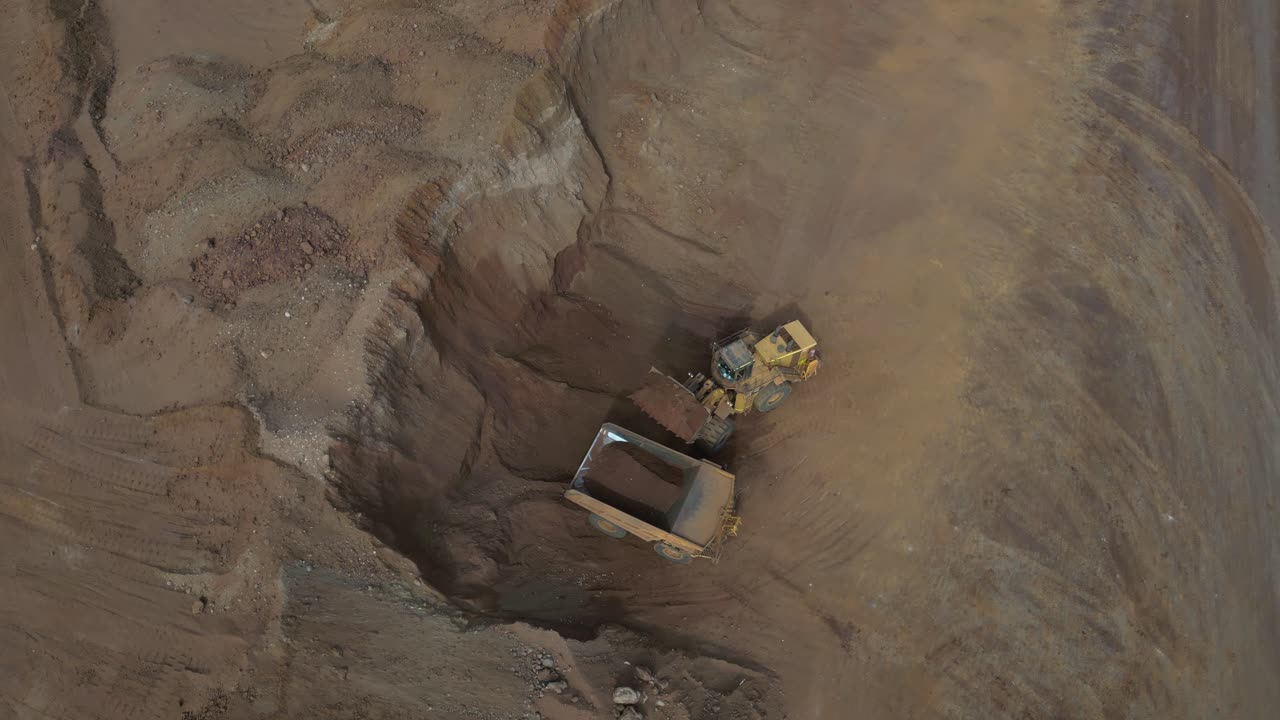 Excavator filling up truck in nickel mine site