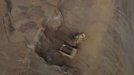 excavator filling up truck in nickel mine site