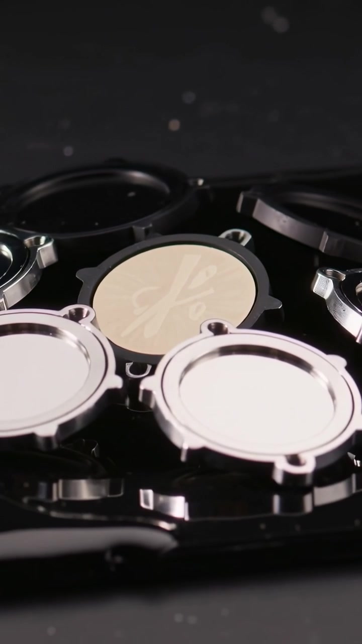Vertical video: Panning camera on play revealing embossed beige insert on black tray, showing rings