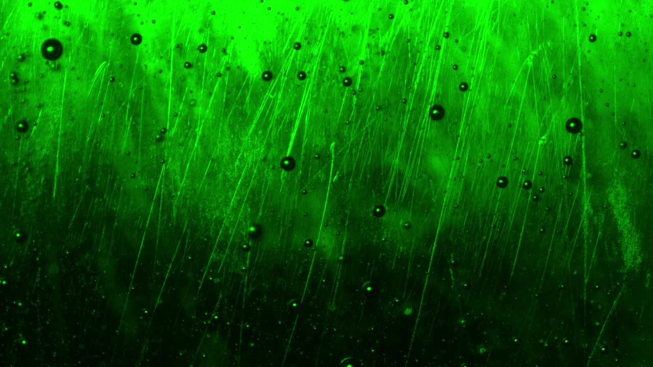 primer plano de un líquido verde con burbujas surrealistas que fluyen hacia arriba, creando un componente visual abstracto e irreconocible