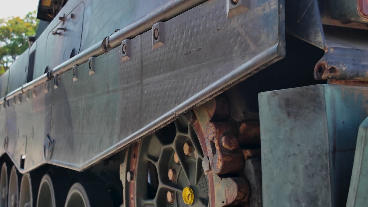 Detailed view of the complex mechanics of tank tracks, highlighting their robust construction and military application