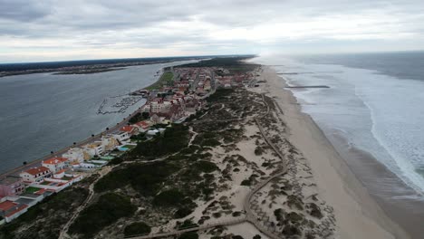 Aerial-view-of-colorful-coastal-houses-near-beach-and-ocean