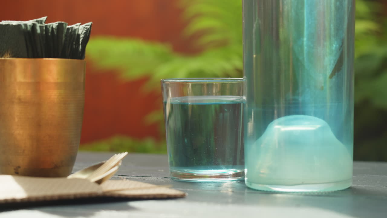 Water Glass and Bottle on a Table