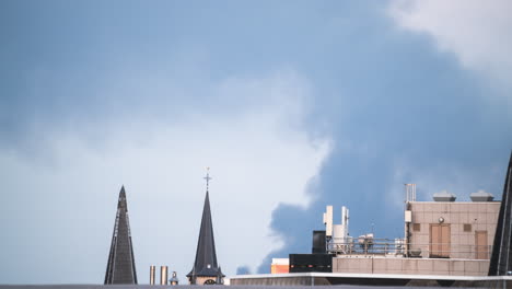 smoke blows over the cross on a steeple