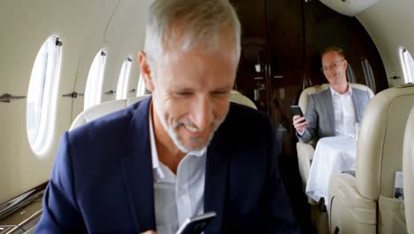 business people interacting with each other while travelling in private jet 4k