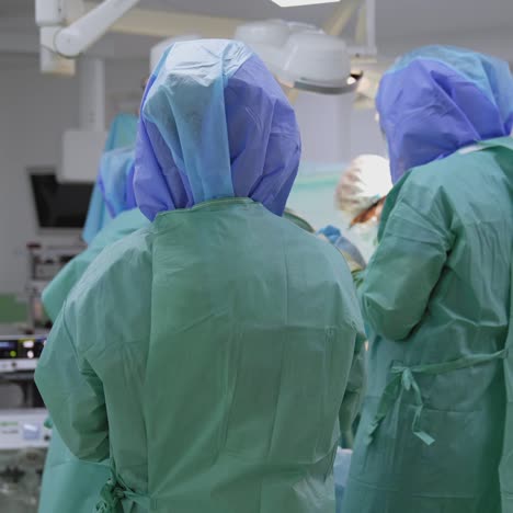 Medical workers in protective uniform in the hospital. Life support equipment during coronavirus pandemic. Covid-19. Rear view