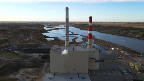 Aerial-4k-time-lapse-of-power-plant-with-two-high-cooling-towers-next-to-large-blue-river-in-north-america