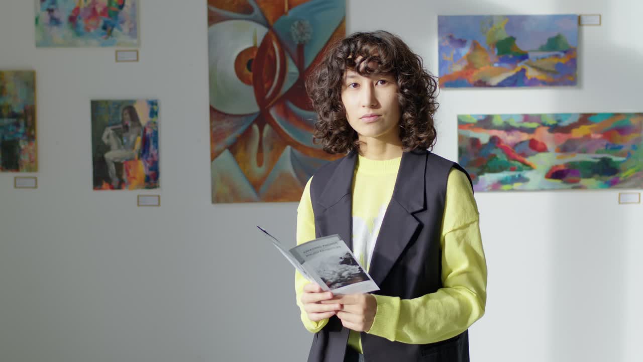 Portrait of Young Woman with Booklet in Art Gallery
